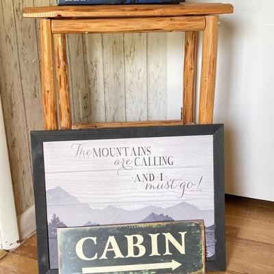 LOT 188: Handcrafted Log Style Side Table, Mountains / Cabin Wall Decor and Collection of Books