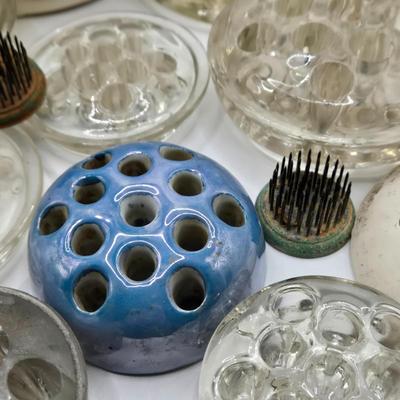 LOT 196: Multiple Glass and Metal Flower Frogs, 2 Planter Pots, and Watering Can with Seeds & Gloves