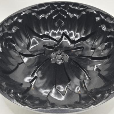 LOT 200: Cookbooks, Specialty Rolling Pins, Bundt Cake Pan, Handmade in Sweden Table Linen , Tile Trivet, Harkerware Serving Dish, and...