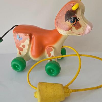 LOT 210: Edward Mobley Co. Arrow Rubber Corp. Horse Pony Squeak Toy, Fisher Price Molly Moo Cow, Handcrafted Wooden Toy Horse, and...