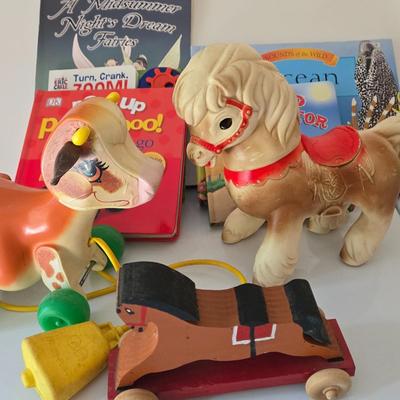 LOT 210: Edward Mobley Co. Arrow Rubber Corp. Horse Pony Squeak Toy, Fisher Price Molly Moo Cow, Handcrafted Wooden Toy Horse, and...