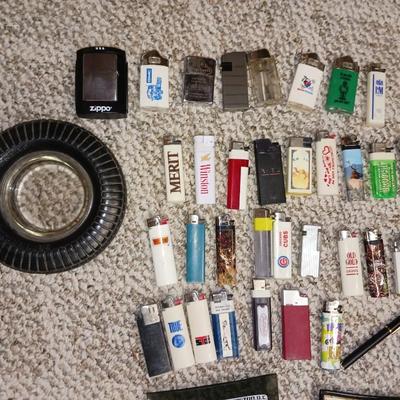 RUBBER TIRE AND GLASS ASHTRAYS PLUS MANY LIGHTERS