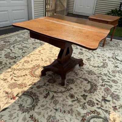 Drop leaf table with music scroll motif base