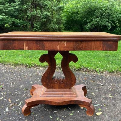 Folding table with music scroll motif base