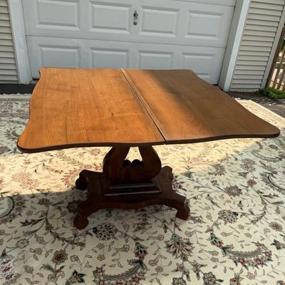 Folding table with music scroll motif base