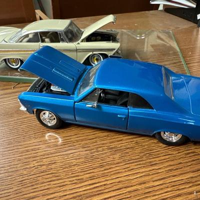 Sale Photo Thumbnail #22: Both on display at the ReStore 
Blue car is 1/24 scale. Back wheel pops off. 
1958 Danbury mint