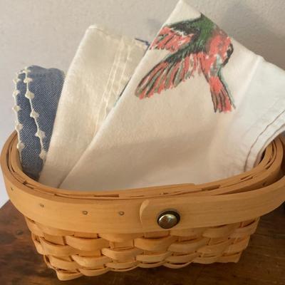 Small basket with dish towels and vintage sifter