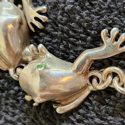 Sale Photo Thumbnail #325: This auction lot is for a Sterling Army of Frogs Bracelet.  These wonderfully handsome 8 sterling frogs are all strung together to form a stunning fashion piece.  Where are you gonna find one of these?  The bracelet weighs about 45.4 grams.  See photo for