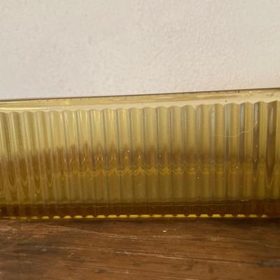 Amber glass ice box with vintage books
