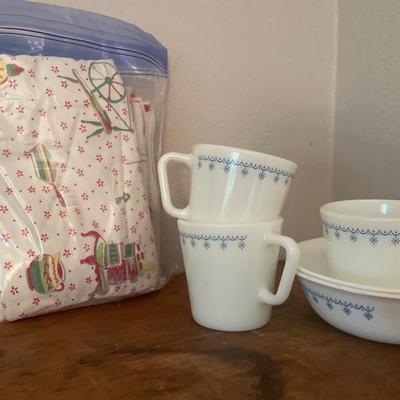 Prairie book with Pyrex mugs/bowls, blue bowl and fabrics napkins