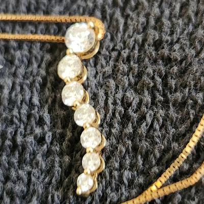 Sale Photo Thumbnail #363: This auction lot is for a 14K Gold & Diamond Necklace.  This petite and fine gold necklace sports a dangle of real diamonds - 7 total in descending carats.  A nice showy, but not too showy fashion item.  The necklace with the stones weighs about 2.8 grams