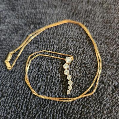 Sale Photo Thumbnail #361: This auction lot is for a 14K Gold & Diamond Necklace.  This petite and fine gold necklace sports a dangle of real diamonds - 7 total in descending carats.  A nice showy, but not too showy fashion item.  The necklace with the stones weighs about 2.8 grams