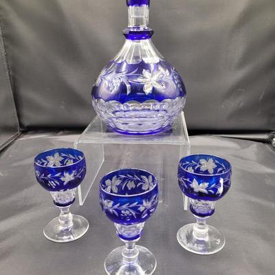 Sale Photo Thumbnail #456: Cobalt blue cut to clear decanter, 9 inches tall.  Glasses are 4 inches tall. 
Grapevine pattern.  Excellent condition.  
Retails at $100+