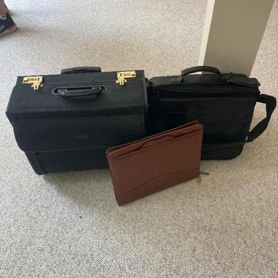 Three briefcase/ bags, two black, one brown leather