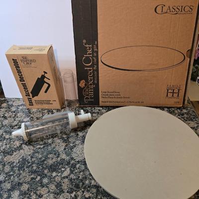 Assortment of The Pampered Chef kitchen items and Large Round Stone