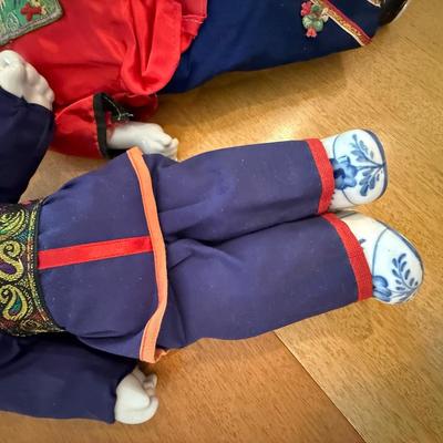 Pair of Chinese dolls with porcelain heads and feet