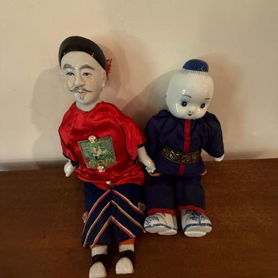 Pair of Chinese dolls with porcelain heads and feet