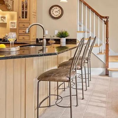 Four leather and metal counter height stools