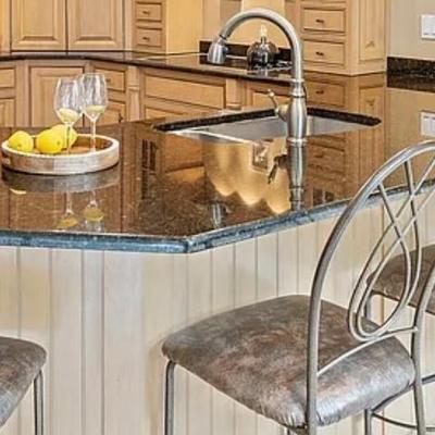 Four leather and metal counter height stools