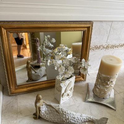 Small gold mirror and ocean themed decor