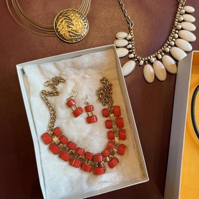 Four pretty necklaces and matching earrings