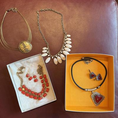 Four pretty necklaces and matching earrings