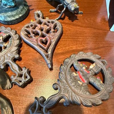 Antique metal trivets and animal figures