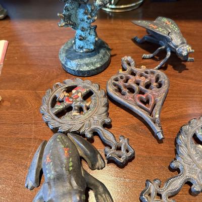 Antique metal trivets and animal figures