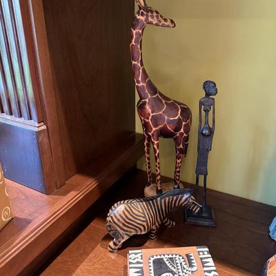 Four African pieces including giraffe , zebra and tribal figure