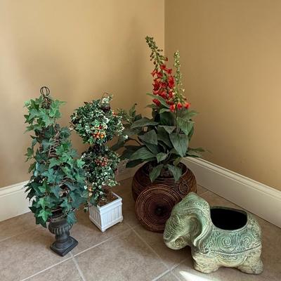 Three beautiful faux flower arrangements and ceramic plant holder
