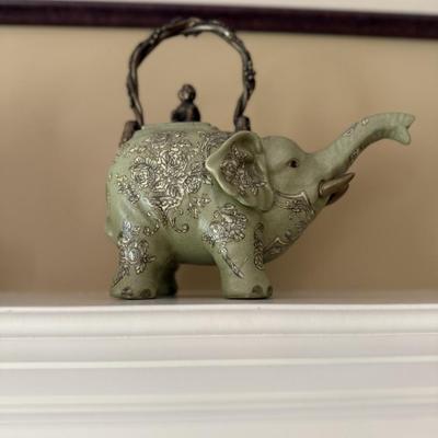 Four Asian figures and elephant