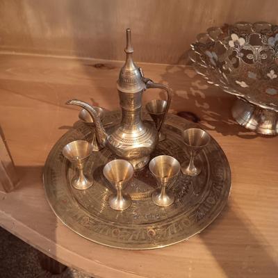 SMALLER BRASS DECANTER AND STEMMED CUPS ON A BRASS TRAY PLUS A COLORIZED BRASS BOWL