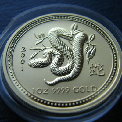 Sale Photo Thumbnail #21: This 2001 gold 1-oz coin from the Perth Mint features the Australian Lunar Series I design for the Year of the Snake.
 
 
The coin is in BU (Brilliant Uncirculated) condition.  It's one troy ounce of pure gold and has a proof-like strike type.  It is what