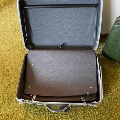 Sale Photo Thumbnail #22: Three hard-shell suitcases including a Samsonite piece and two unbranded suitcases. The Samsonite case features black textured exterior and branding on the latch hardware. The second case is green with a light interior, and the third is a darker, smaller 