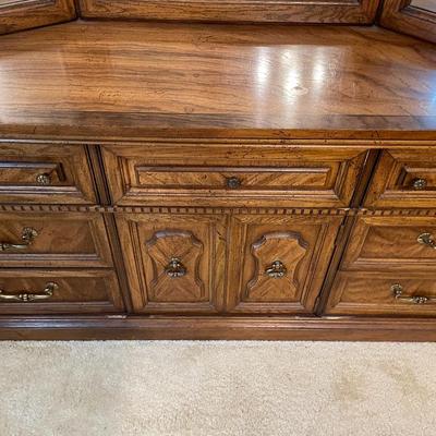Sale Photo Thumbnail #29: Wooden dresser with a tri-fold beveled mirror. The dresser features a six-foot-wide surface with a total of nine storage compartments, including both drawers and cabinet-style doors. Dimensions include approximately 6' 1" in width, 42 1/2" in height, and 