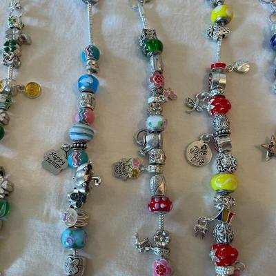 Eleven Charm Bracelets with Glass and Metal Beaded Charms