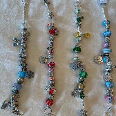 Eleven Charm Bracelets with Glass and Metal Beaded Charms