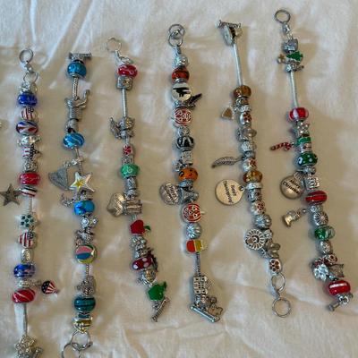 Eleven Charm Bracelets with Glass and Metal Beaded Charms