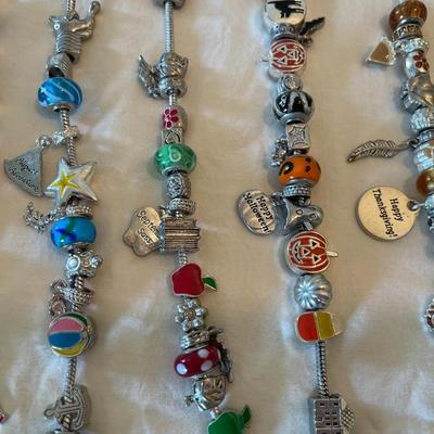 Eleven Charm Bracelets with Glass and Metal Beaded Charms