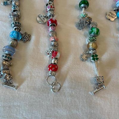 Eleven Charm Bracelets with Glass and Metal Beaded Charms
