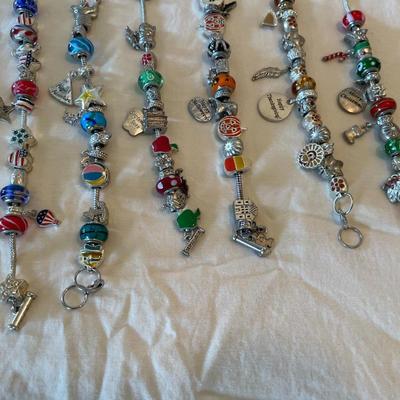 Eleven Charm Bracelets with Glass and Metal Beaded Charms