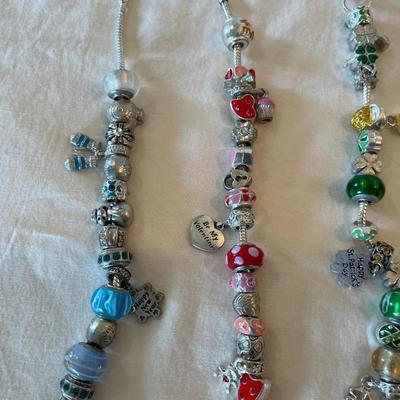 Eleven Charm Bracelets with Glass and Metal Beaded Charms