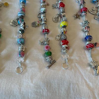 Eleven Charm Bracelets with Glass and Metal Beaded Charms