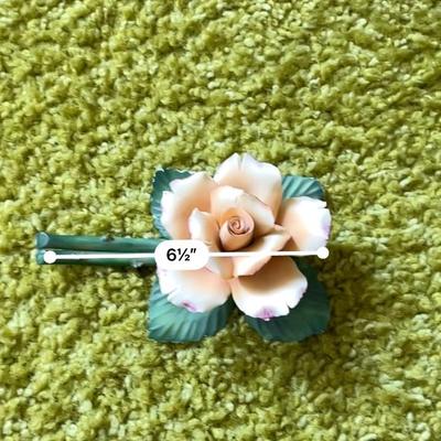 Sale Photo Thumbnail #127: Handmade ceramic rose crafted by Fabar Italy, from the Porcellane Artistiche collection. Features a detailed design with green leaves and a stem measuring approximately 6.5 inches in length. The piece includes stamps on the back indicating the maker and o