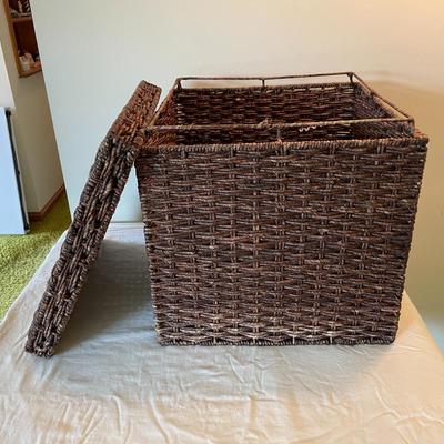 Sale Photo Thumbnail #197: Square wicker storage basket featuring a removable lid. Constructed with woven wicker material and measuring 18 inches on each side. Medium brown color with a sturdy, structured design suitable for storage or decorative purposes. The lid fits securely and