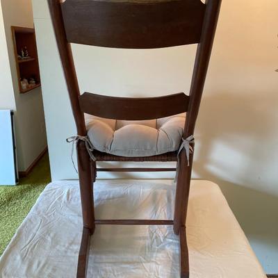 Wooden Ladder-Back Rocking Chair With Woven Seat and Cushion