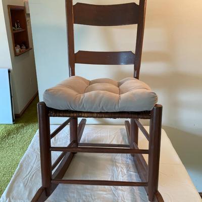 Wooden Ladder-Back Rocking Chair With Woven Seat and Cushion