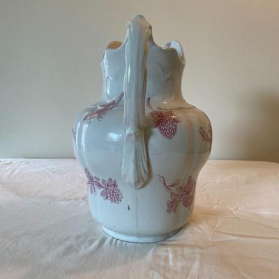 Sale Photo Thumbnail #220: A traditional ironstone pitcher and basin set featuring a white glaze with pink floral decorations. The set includes one round basin measuring 14 inches in diameter and one pitcher standing 11 inches tall. The pitcher has an ornate handle and spout. The b