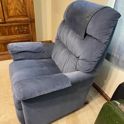 Sale Photo Thumbnail #296: Blue upholstered recliner chair with an extendable footrest. The chair features a cushioned high backrest, padded armrests, and wooden accents on the reclining lever. Approximate dimensions shown include a seat width of 33 inches, seat depth of 25 inches,