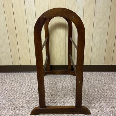 Sale Photo Thumbnail #323: Wooden quilt or blanket rack featuring a curved arched design on both sides with three horizontal rods for hanging. Dimensions are approximately 26 3/4 inches wide, 13 1/2 inches deep, and 29 inches tall. Constructed from finished wood with visible screws